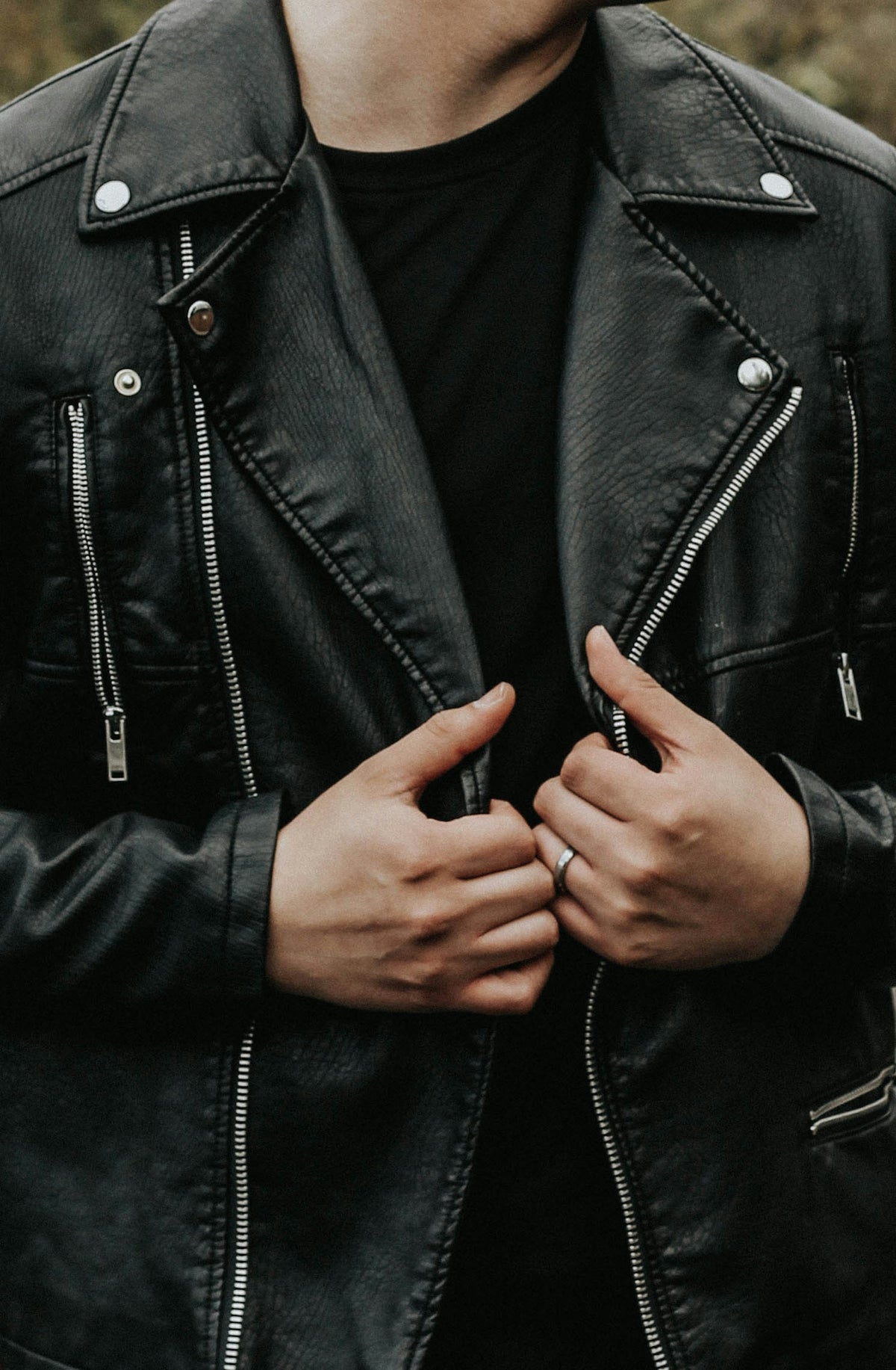 Man holding a leather jacket